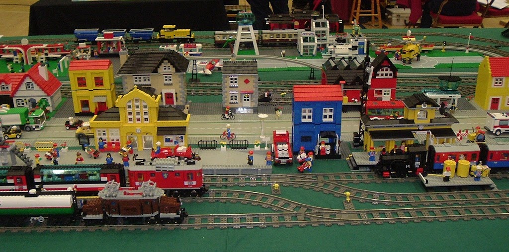 Lego houses next to 3 railway lines.