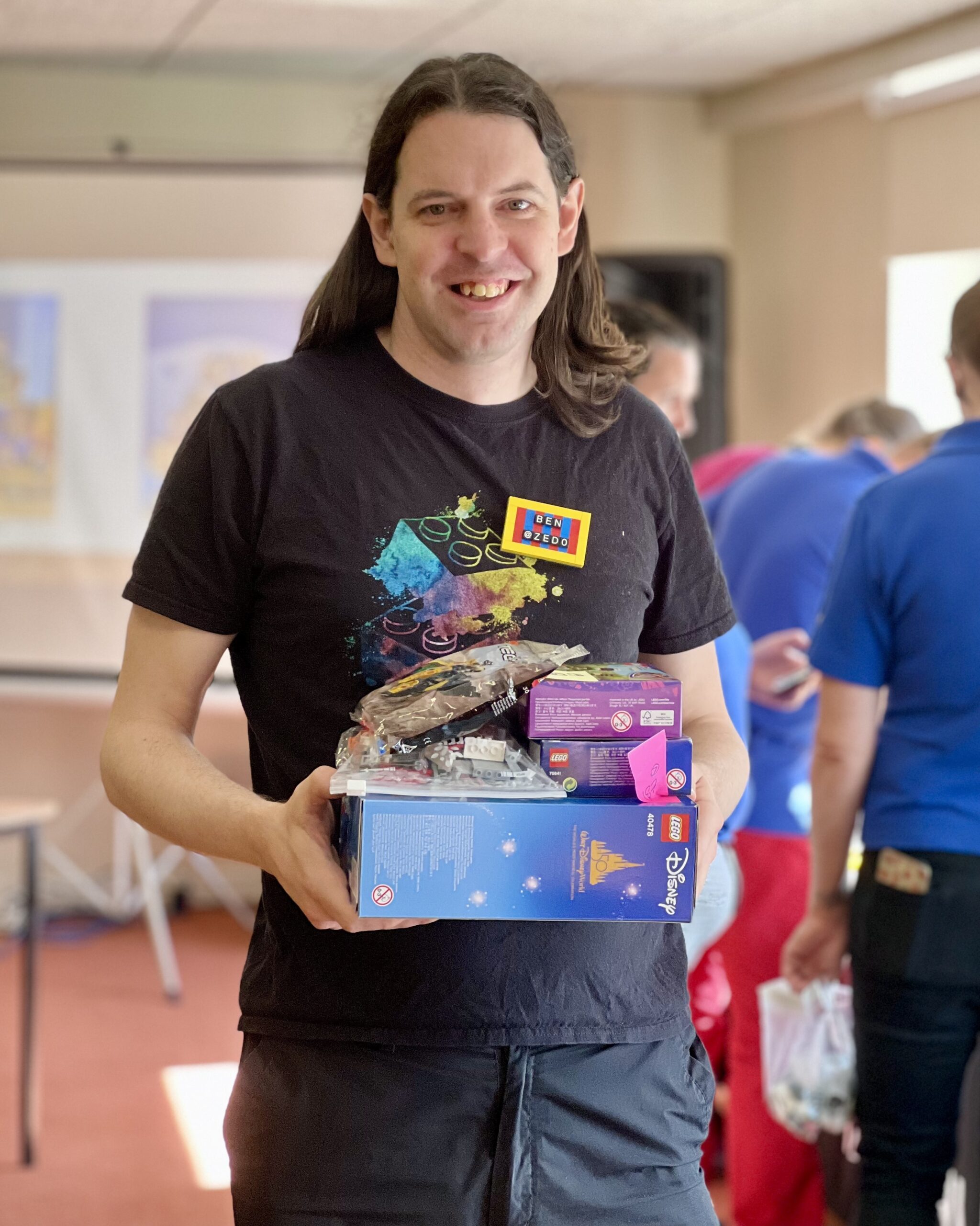 Ben holding his pile of prizes, including mini Disney castle.